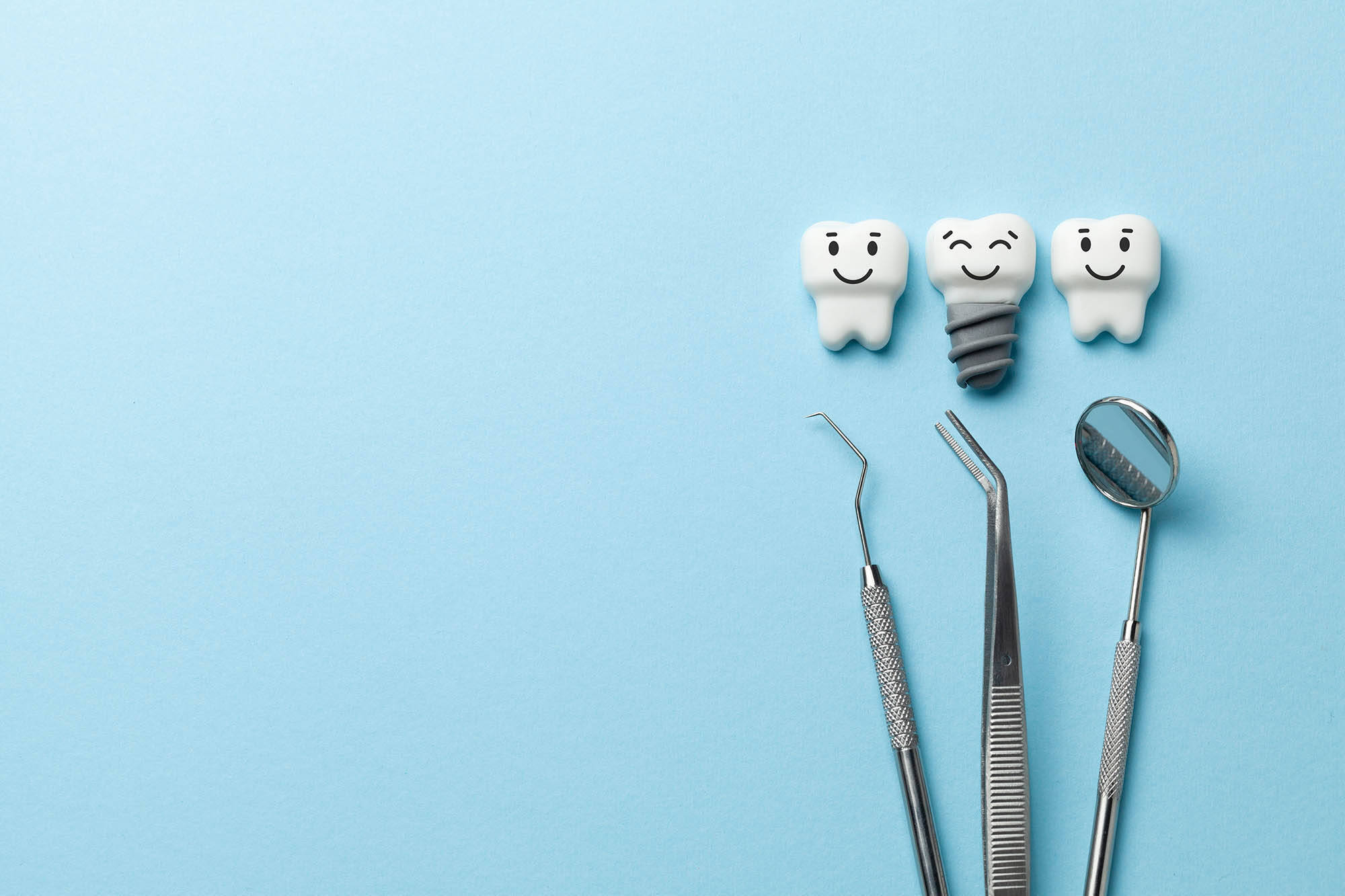Healthy white teeth and implants are smiling on blue background